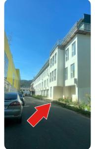 a car driving down a street with a red arrow at Studio Factory 22 in Braşov
