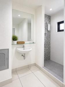 a white bathroom with a sink and a shower at Monalisa Blue haven pool hotel in Pattaya South +26 photos