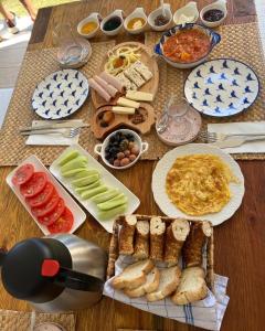 a table topped with plates of food on top at Chloe hotel Alaçatı in Alaçatı