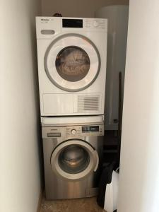 two washing machines are stacked on top of each other at La croix des granges - le gîte in Chapdeuil