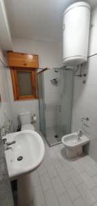 a bathroom with a toilet and a sink and a shower at Bellacation in Letojanni +29 photos