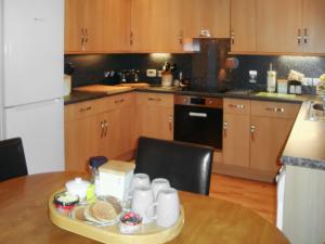 a kitchen with a table with a tray of food on it at The Old Store in Onich