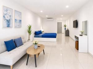 a living room with a couch and a bed at Monalisa Blue haven pool hotel in Pattaya South
