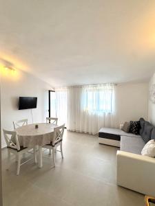 a living room with a table and a couch at Apartments Ema in Sali