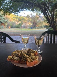 a plate of food on a table with two wine glasses at La Gran Vigne in Salernes