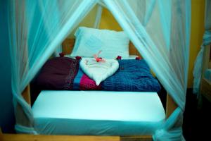 a bedroom with a bed with a canopy at Kilimanjaro Simba Lodge in Moshi