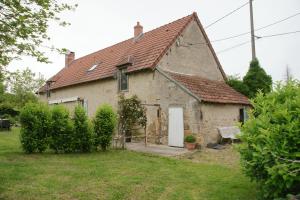 an old stone house with a white door at Sans Soucis in Épineuil-le-Fleuriel