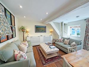 a living room with a couch and a table at Grange Cottage in Langham