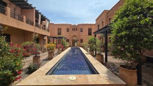 a swimming pool in a courtyard of a building at Villa Yacout Marrakech -Private Pool in Sraghna