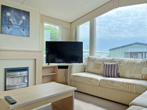 a living room with a couch and a television at Forest Edge - Uk51739 in Oakmere