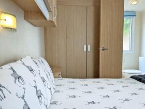 a small bedroom with a bed and a cabinet at Forest Edge - Uk51739 in Oakmere +7 photos