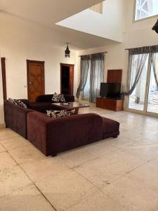 a large living room with a couch and a tv at Carlton Luxury Villa in Sharm El Sheikh