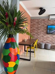 a colorful vase with a plant in a room at Hotel Aeroporto Star in Fortaleza