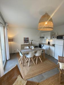 a kitchen and dining room with a table and chairs at Villa Léonie in Bonifacio