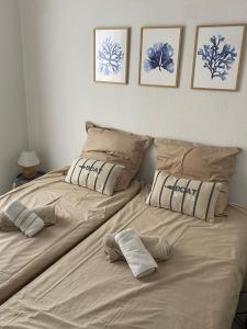 a bed with two pillows on it in a bedroom at Villa Léonie in Bonifacio +37 photos