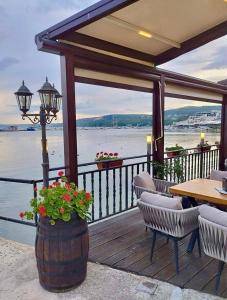a patio with a table and chairs and a view of the water at Dream Sea Holiday in Balchik