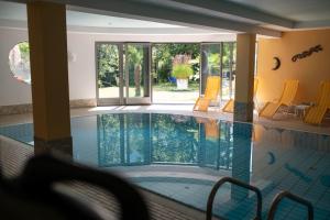 a large swimming pool with chairs in a house at Hotel St. Pankraz in San Pancrazio dʼUltimo +66 photos