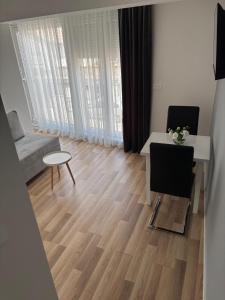 a small living room with a table and a couch at COMFORT APARTMENTS M&S in Mostar