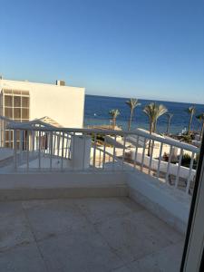 a balcony with a view of the ocean at Carlton Luxury Villa in Sharm El Sheikh