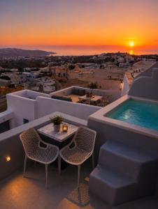a balcony with a table and chairs and a sunset at Suntora in Pyrgos