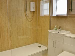 a bathroom with a shower and a sink at Haven Cottage - E4342 in Holy Island