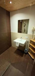 a bathroom with a sink and a shower at valbel in Sankt Anton am Arlberg +71 photos