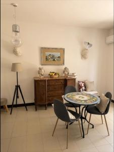 a living room with a table and chairs at BlueSkyLite in Taormina +21 photos