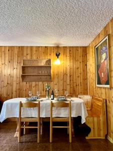 a dining room with a table and two chairs at Dimaro Apartment in Monclassico