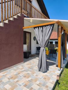 a patio with a curtain and a staircase at Apartman Turkalj in Rakovica
