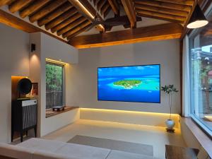 a living room with a large screen tv on the wall at Hyu Stay in Gyeongju