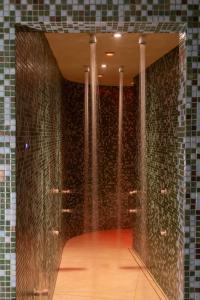 a hallway with a wall of glass tiles at Legacy Ithos Boutique Hotel in Porto Santo