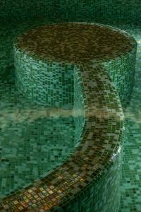 a fountain in a room with a mosaic floor at Legacy Ithos Boutique Hotel in Porto Santo +14 photos
