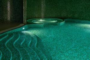 a swimming pool with a tub in a bathroom at Legacy Ithos Boutique Hotel in Porto Santo