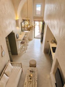 an attic living room with a table and a dining room at Selora Cave in Pyrgos