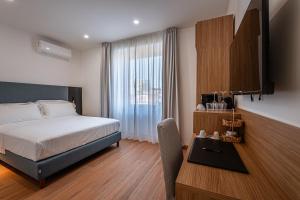 a hotel room with a bed and a table with a table at 266 La Barraca in Torvaianica