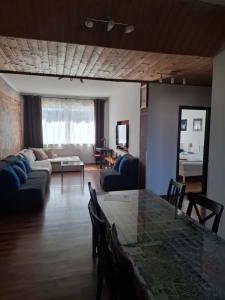 a living room with a table and a couch at Apartment Maximilian in Bratislava