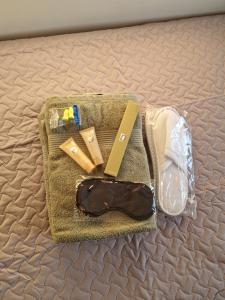 a bag with a knife and other items on a bed at Mini apartment for one person in Tallinn