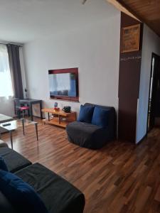 a living room with a couch and a table at Apartment Maximilian in Bratislava