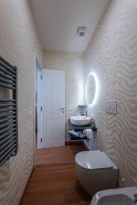 a bathroom with a white toilet and a sink at 266 La Barraca in Torvaianica +67 photos