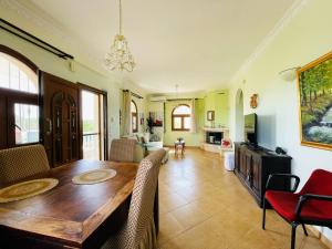 a dining room with a wooden table and chairs at The Greek Mama's Cottage in Epanomi