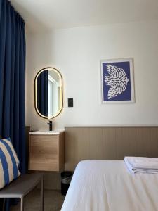 a bedroom with a bed and a mirror at Residentie Sweetnest met hotelservice à la carte - 3 dubbel kamers in Knokke-Heist