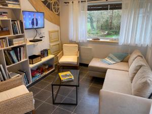 a living room with a couch and a table at Gite Gavotte in Concarneau