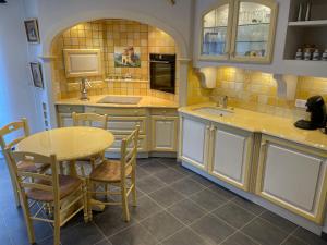 a kitchen with a table and a table and chairs at Gite Gavotte in Concarneau