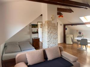 a living room with a couch and a table at Apartmán Silvia in Komárno