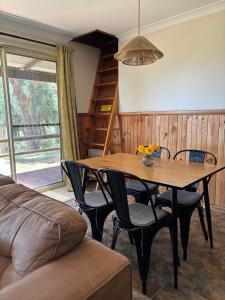 a dining room with a wooden table and chairs at Augusta Sheoak Chalets in Augusta +86 photos