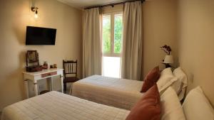 a hotel room with two beds and a window at Agriturismo Ca' Brusca in Due Maestà