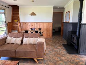a living room with a couch and a fireplace at Augusta Sheoak Chalets in Augusta