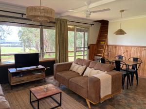 a living room with a couch and a table at Augusta Sheoak Chalets in Augusta