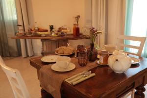 a wooden table with a tea set on it at Agriturismo Ca' Brusca in Due Maestà