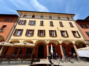 a large building with bikes parked in front of it at Green House Historic Centre in Bologna